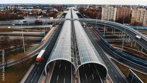 Warsaw, Poland, 03.20.2020. - The anti-noise glass tunnel and overpass Trasa Torunska highway in north-east Warsaw.