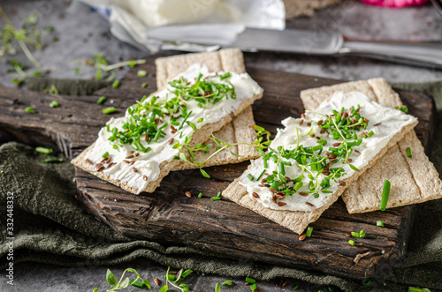 Delicious fresh cheese with herbs on crispbread