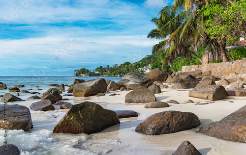 Scenic beach with rocks and white sand at the Indian ocean, Seychelles.