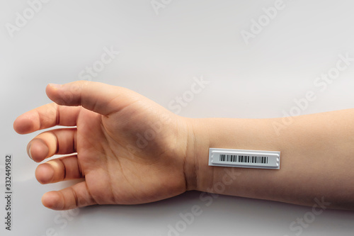 Bar code is on  the child hand. Copy space.  Clone of DNA and human genome. The concept child trafficking, digital concentration camps , electronic cards.