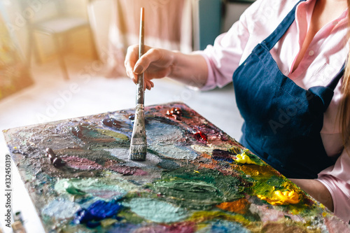 girl holds a brush near the palette photo