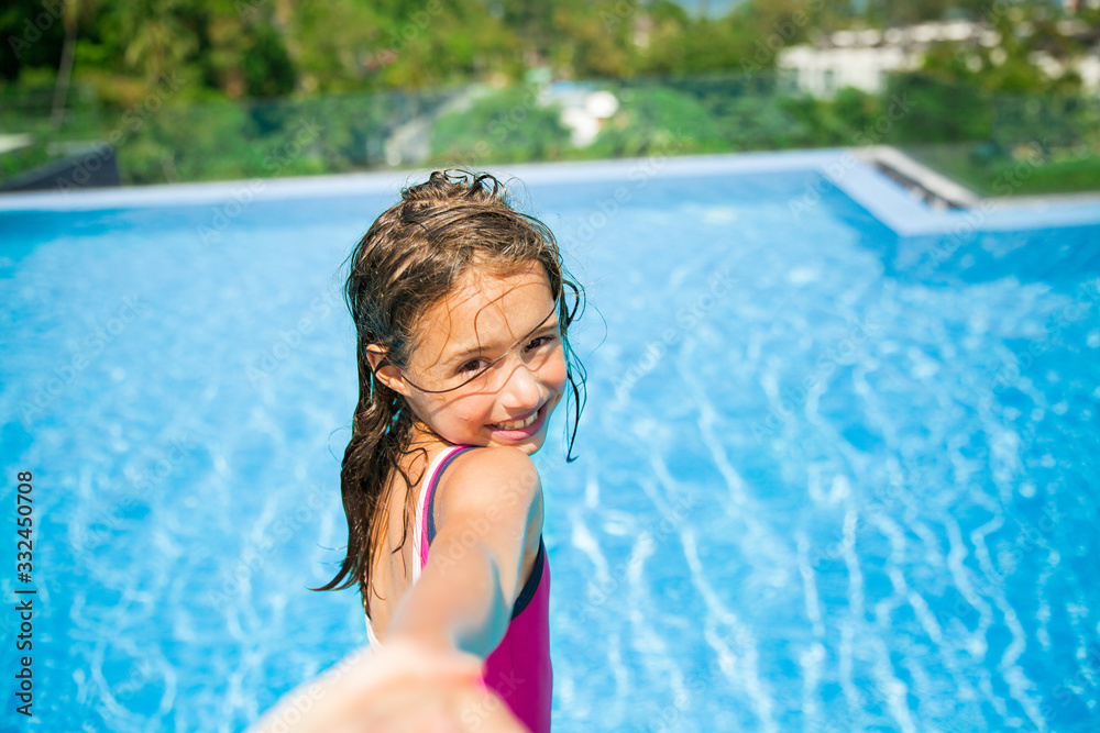 Excited happy little girl leading parent by the hand jumping into the swimming pool. Happy summer vacation. Follow me concept. 