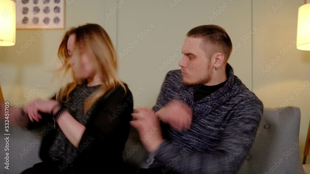 young couple fights on a sofa young couple fights on a sofa