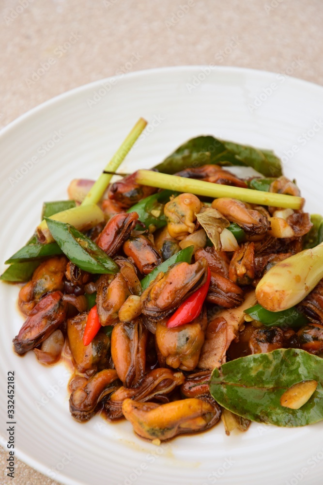 Oseng Kerang Saus Tiram, Indonesian food. Stir-fried mussels with oyster sauce, soy sauce, lemongrass, bayleaf, ginger, garlic and chili. Oseng Kerang Saus Tiram, Indonesian food. Stir-fried mussels with oyster sauce, soy sauce, lemongrass, bayleaf, ginger, garlic and chili.