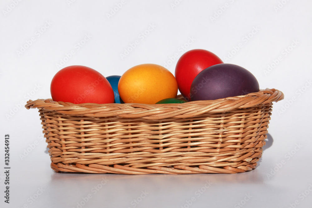 Easter eggs colors in basket white background Easter eggs colors in basket white background