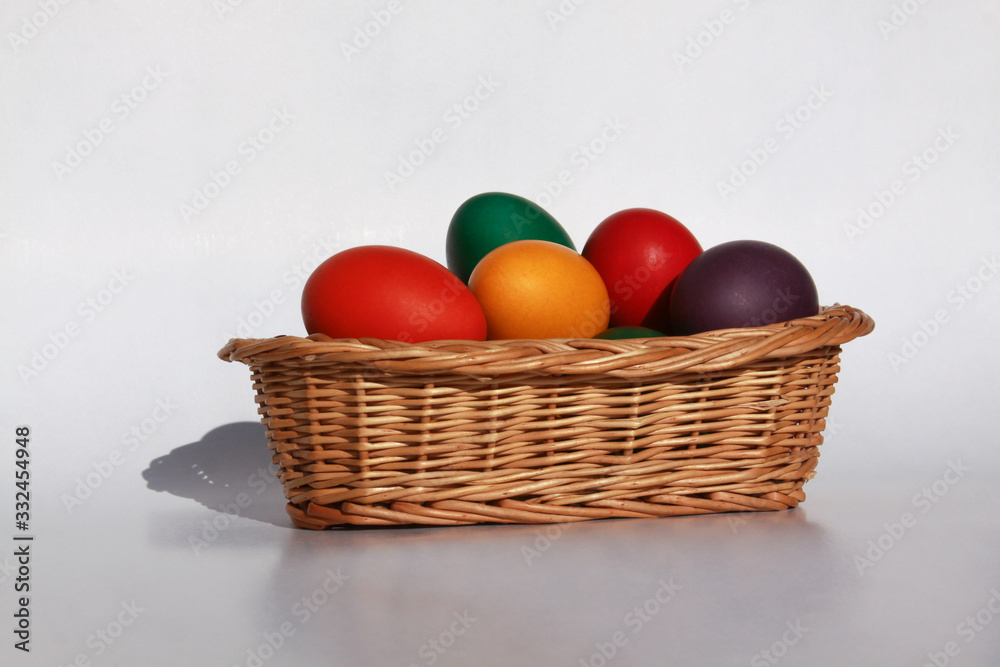 Easter eggs colors in basket white background Easter eggs colors in basket white background