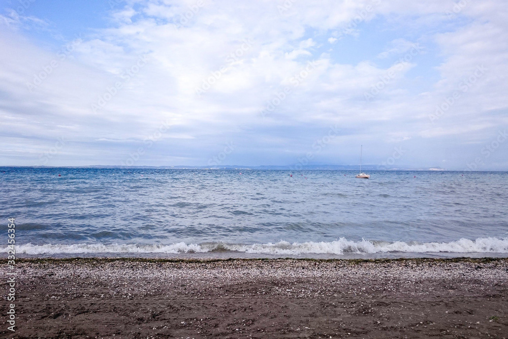 Waterside at a summer day, surge at Lake Garda