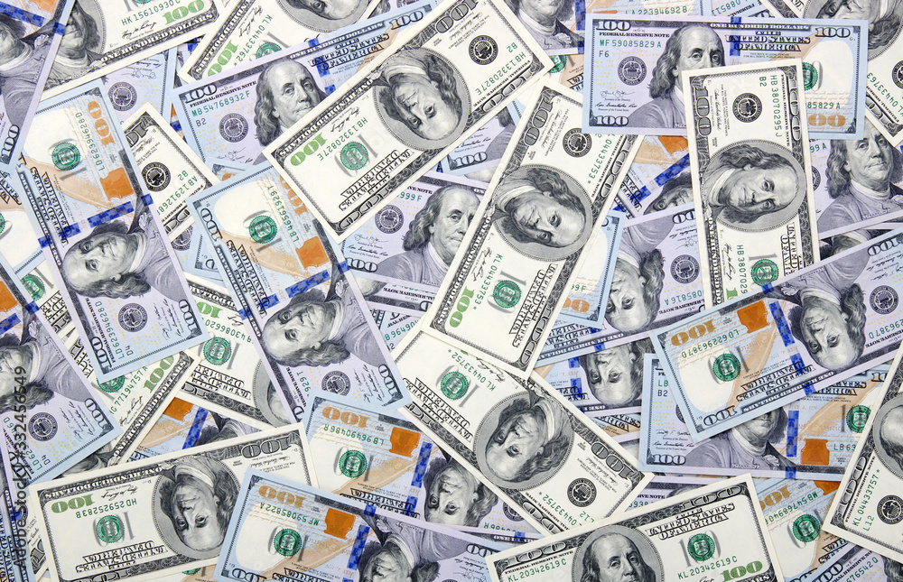 Heap of one hundred dollar bills on money Heap of one hundred dollar bills on money