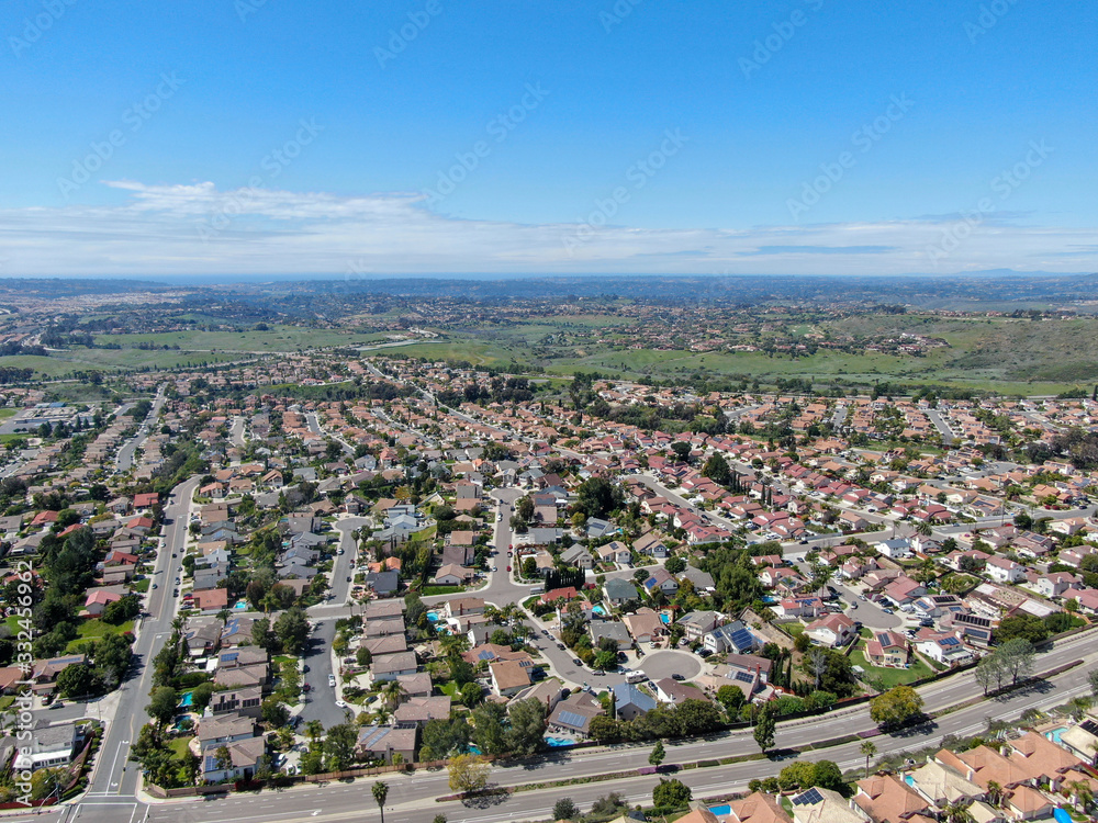 Aerial view of upper middle class neighborhood with residential subdivision houses during sunny day in San Diego, California, USA.