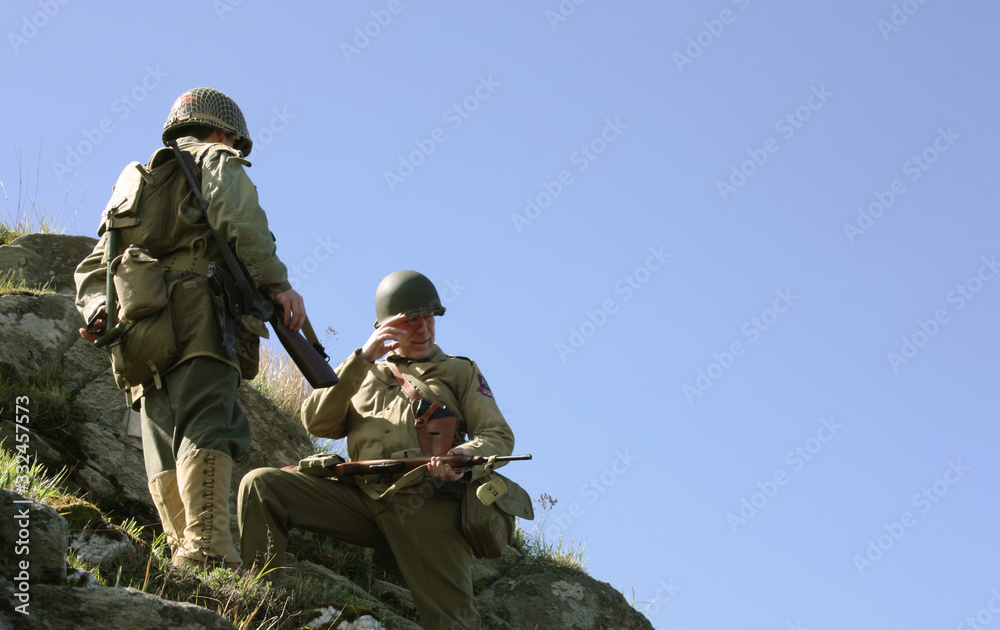 Fototapeta premium American allied soldiers in trench uniforms fight German enemies along the Gothic Line in a historical reenactment