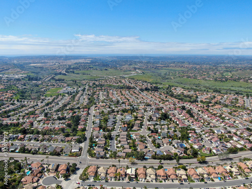 Aerial view of upper middle class neighborhood with residential subdivision houses during sunny day in San Diego, California, USA.