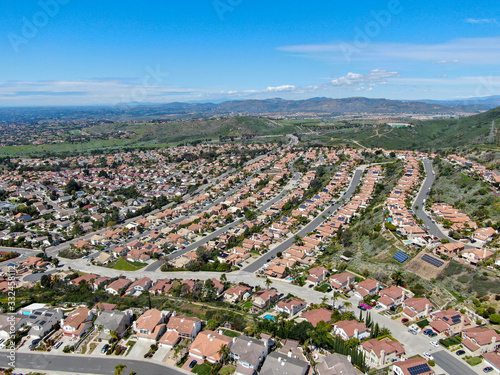 Aerial view of upper middle class neighborhood with residential subdivision houses during sunny day in San Diego, California, USA. © Unwind