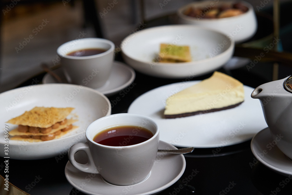Sweets dessert cookies cake and teapot with cups Sweets dessert cookies cake and teapot with cups