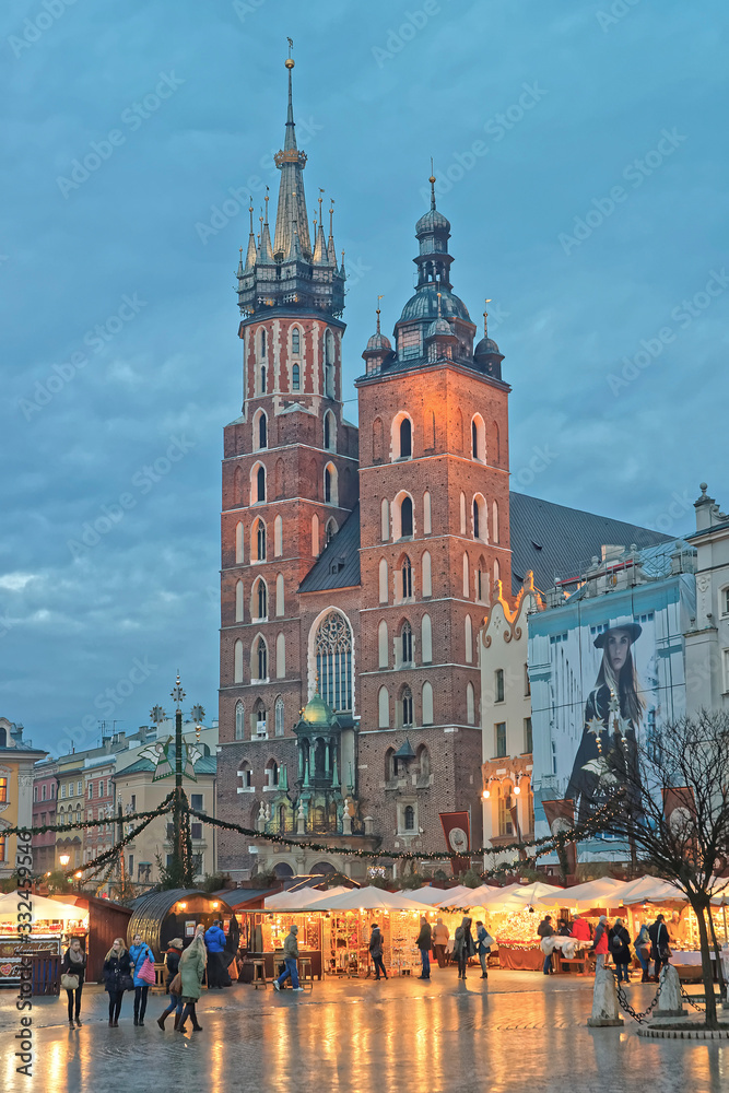 St Mary Basilica and the street market in the Main Market Square of the Old City in Krakow in Poland at Christmas