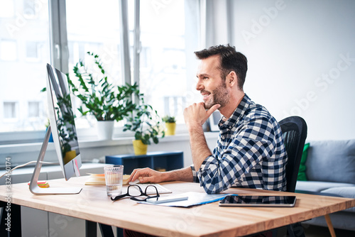 Successful freelancer working on computer while staying at home