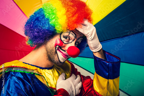 Foto Funny clown in a colorful background