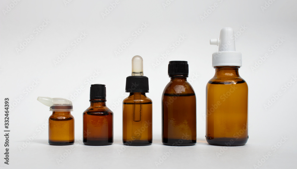 Various amber glass bottles for cosmetics, natural medicine , essential oils or other liquids isolated on a white background.High resolution photo.