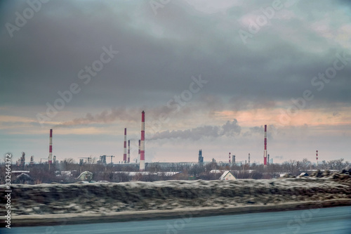 View from the window of a passing car on the Smoking factory chimneys against the overcast sky © pro2audio