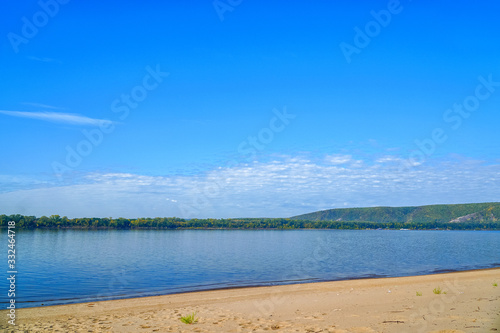 Fototapeta Naklejka Na Ścianę i Meble -  View of a large river with a sandy Bank and forest on opposite side
