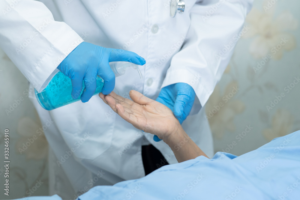 Doctor holding blue alcohol sanitizer gel for patient to protect safety infection and kill Novel Coronavirus (2019-nCoV) Covid-19 virus, bacteria and germs. Doctor holding blue alcohol sanitizer gel for patient to protect safety infection and kill Novel Coronavirus (2019-nCoV) Covid-19 virus, bacteria and germs.