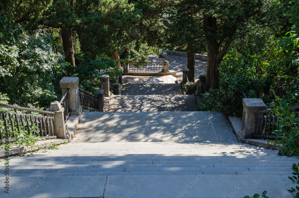 Scenic landscape steep descent on stone staircase in the park
