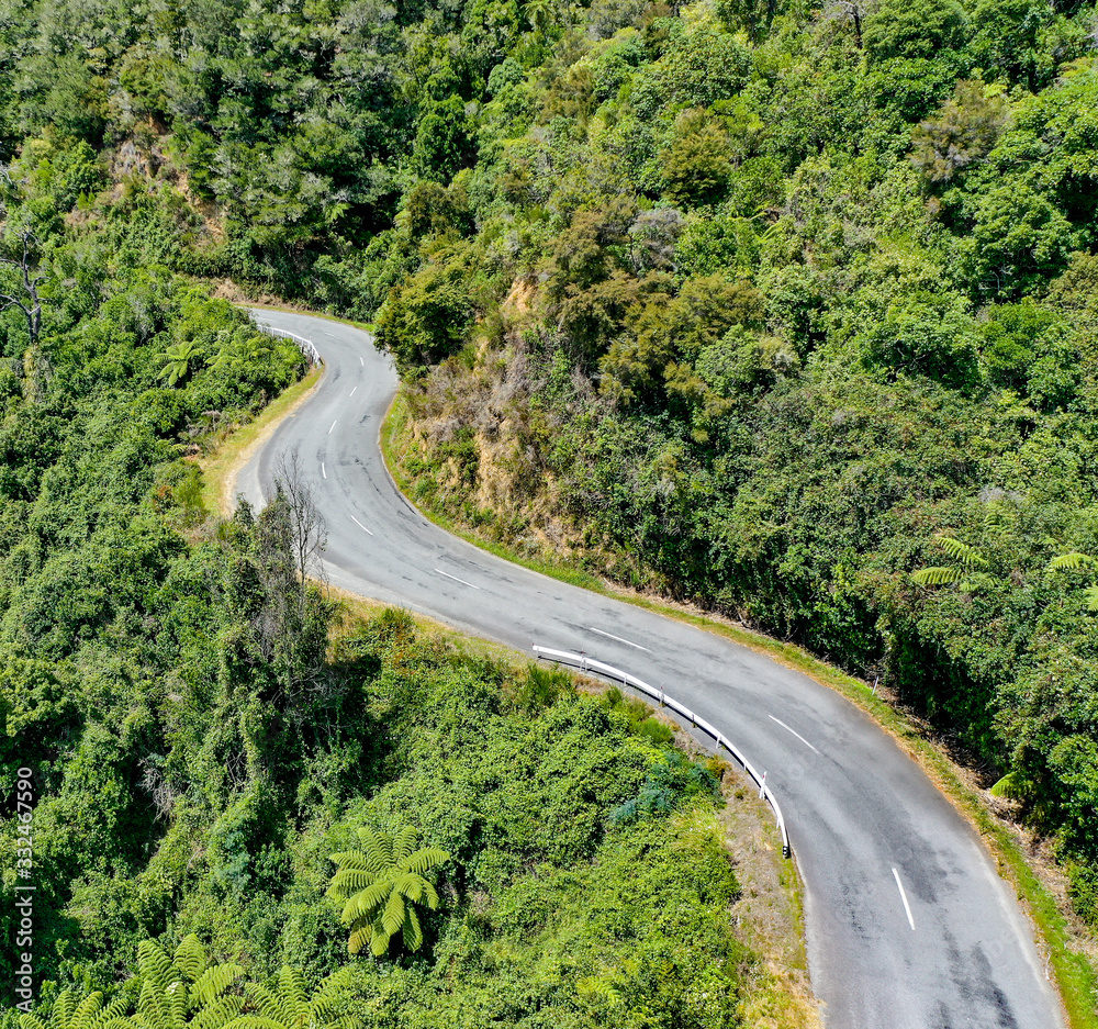 Fototapeta premium Winding Road in the tropical mountains, aerial view