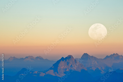 Mountains at sunset seen from the snowy Huaytapallana next to the moon, photography achieved thanks to the use of double exposure from the camera. © Jonathan Chancasana