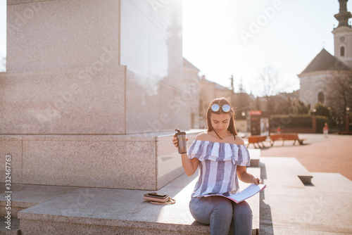  A young beautiful caucasian girl by the monument photo