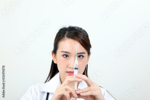 Young asian chinese doctor holding injection syringe needle look at needle on white background