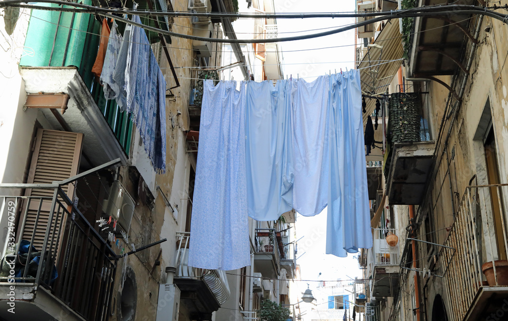 clothes hung out to dry between the terraces of two houses