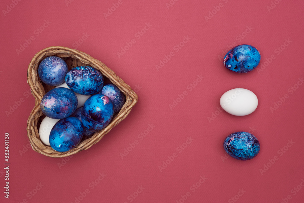 Easter colorful eggs and a basket in the form of a heart on a purple background. Easter colorful eggs and a basket in the form of a heart on a purple background.