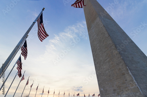 America's national monument, the Washington Monument encircled by American flagpoles at dusk, The Mall, Washington DC photo