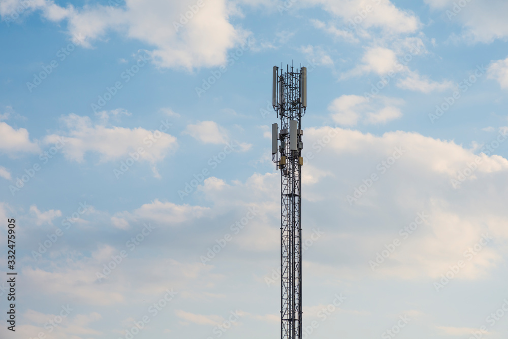 Telecommunication tower with blue sky and white clouds background. Mobile transmitter