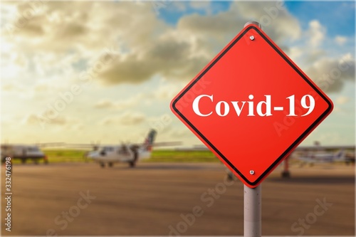A covid-19 word written on a stop sign at the international airport