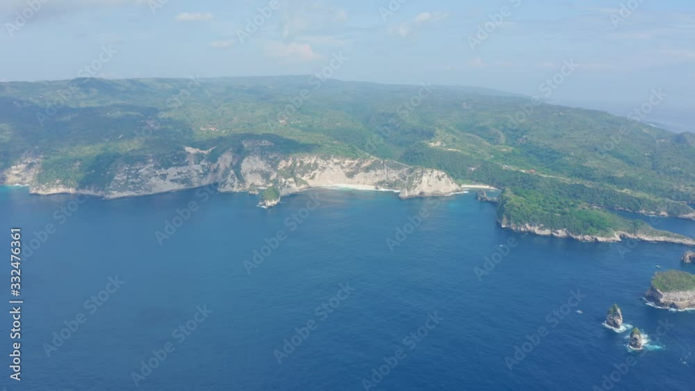 Aerial view of tropical island washed by ocean, Nusa Penida, Bali, Indonesia Aerial view of tropical island washed by ocean, Nusa Penida, Bali, Indonesia