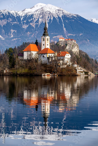 Lake Bled Slovenia. Beautiful mountain lake with small Pilgrimage Church. Most famous Slovenian lake and island Bled with Pilgrimage Church of the Assumption of Maria and Bled Castle in background