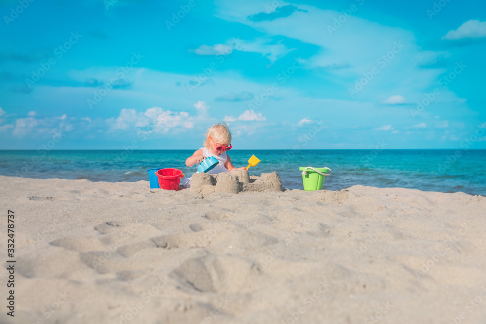 cute little girl play with sand on beach cute little girl play with sand on beach