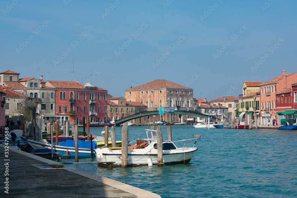 Murano / Venice / Italy - April 17, 2019: View of Murano big canal, Ponte Longo, boats and old buildings