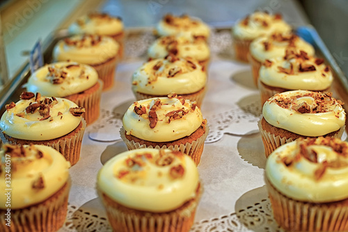 Creamy cupcakes with nuts on the storefront