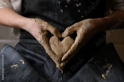 The master works behind the potter's wheel photo