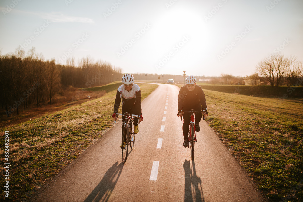  Two senior cyclists on the road