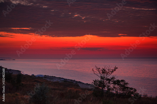 Beautiful red dawn on the coast of the sea. Seascape.