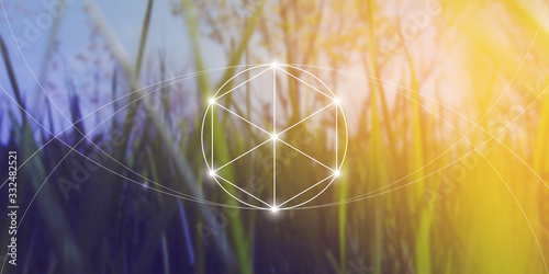 Philosopher stone sacred geometry spiritual new age futuristic illustration with transmutation interlocking circles, triangles and glowing particles in front of blurred background. photo