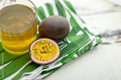 Passion fruit and green tea on a trendy towel. Close-up. On an old wooden table.