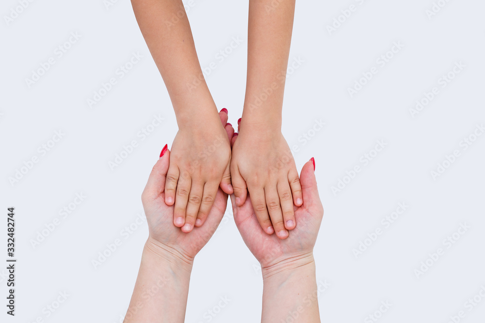 Hands of a baby next to mother's hands, closeup. In the open palm of the mother, two baby hands Hands of a baby next to mother's hands, closeup. In the open palm of the mother, two baby hands