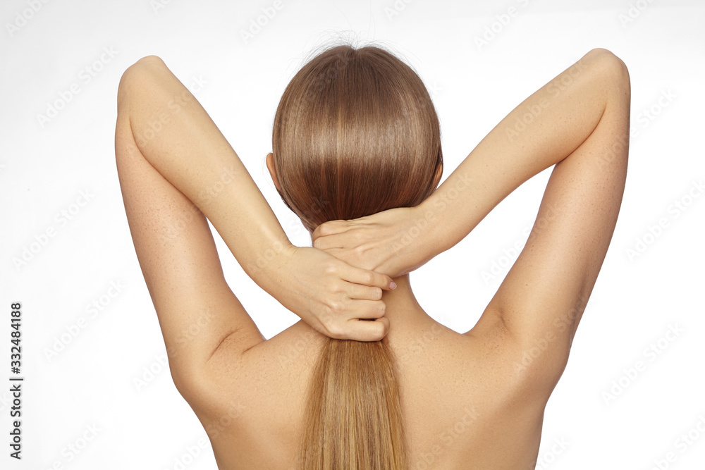 Fototapeta premium Healthy Shiny Long Hair in Tale. Beautiful Girl holding her Hair in hand. Back view of Smooth Hairstyle with strong Hair