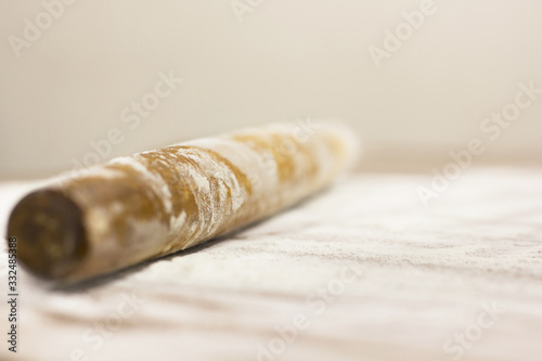 Kitchen rolling pin on flour. Background. To cook