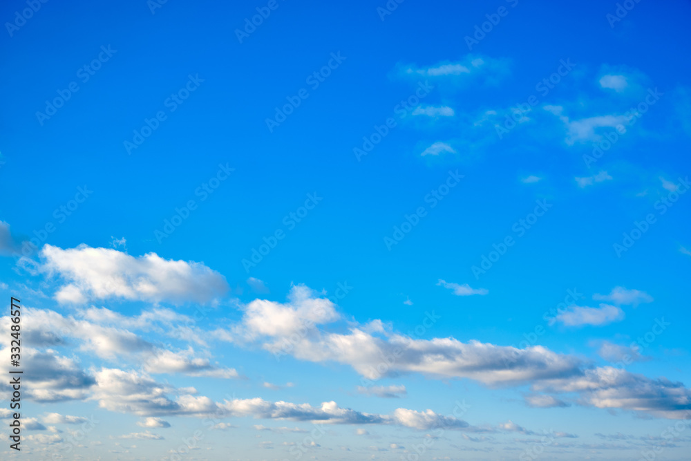 White clouds against a blue sky, copy space. Cloudy sky in clear weather. Cumulus cloud on a sunny winter day. White clouds against a blue sky, copy space. Cloudy sky in clear weather. Cumulus cloud on a sunny winter day.