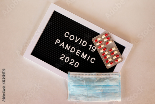 signal indicating COVID19 pandemic 2020 together with protective surgical mask and drugs photo