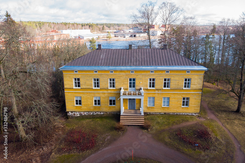 Kouvola, Finland - 19 March 2020: Aerial view of beautiful yellow old building of abandoned Anjala manor. photo